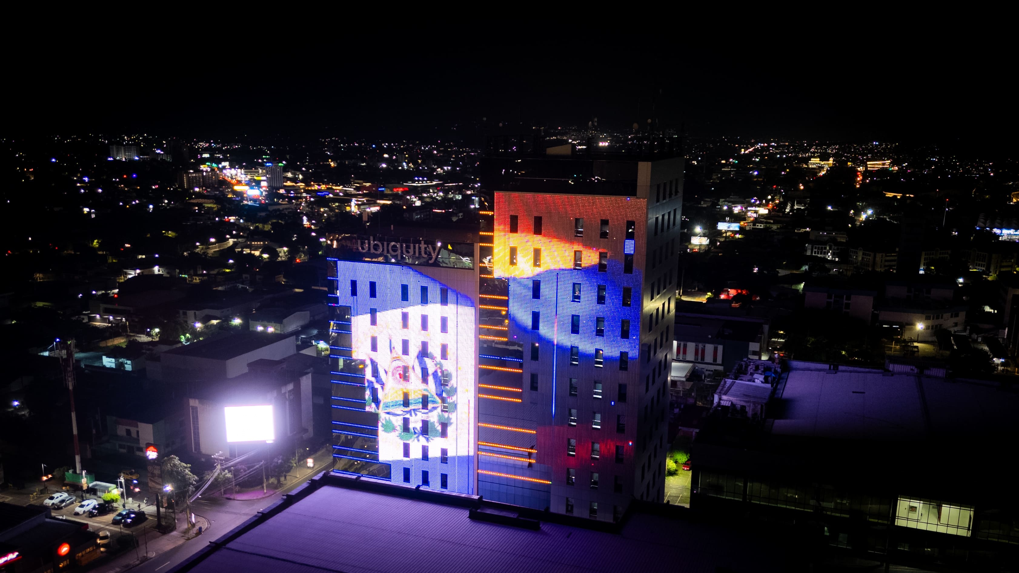 Las torres del Centro Financiero Gigante, iluminadas con las banderas de Colombia y El Salvador